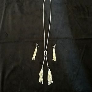 Silver toned tassel necklace with earrings.